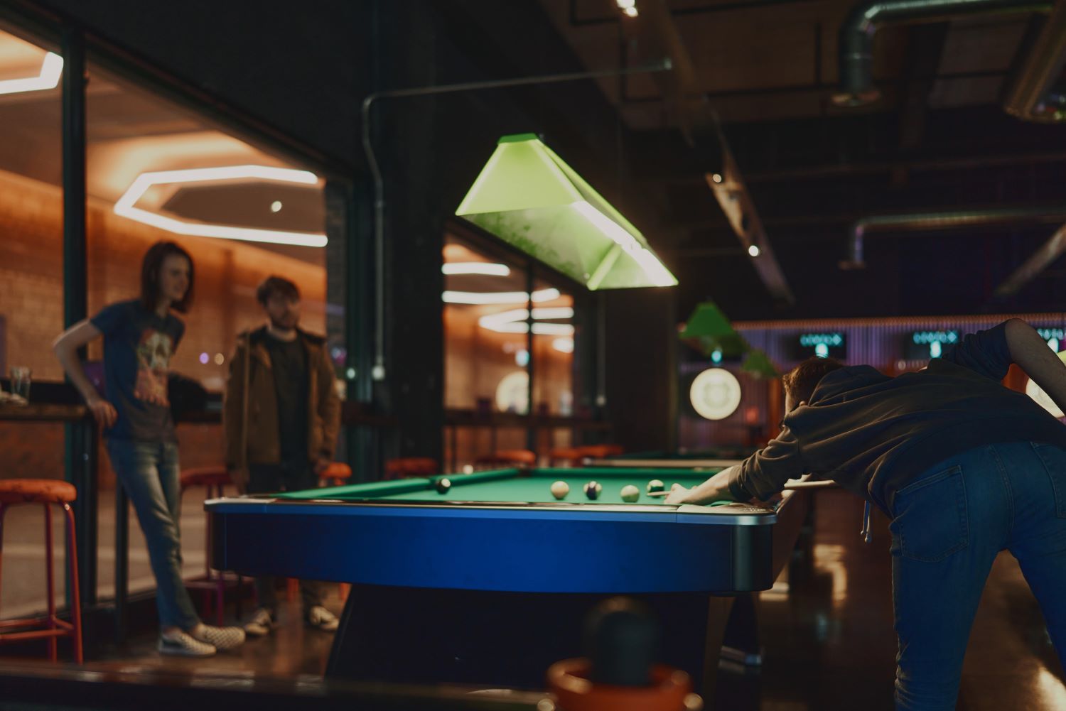 Kids and young people play pool at Level X