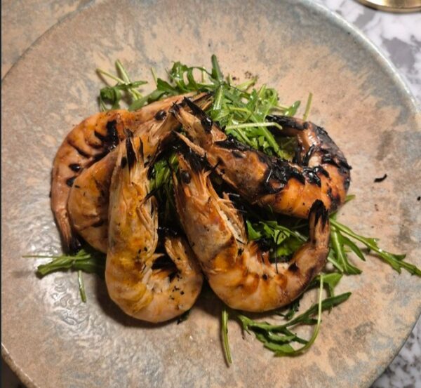 Blackened prawn and rocket garnish starter
