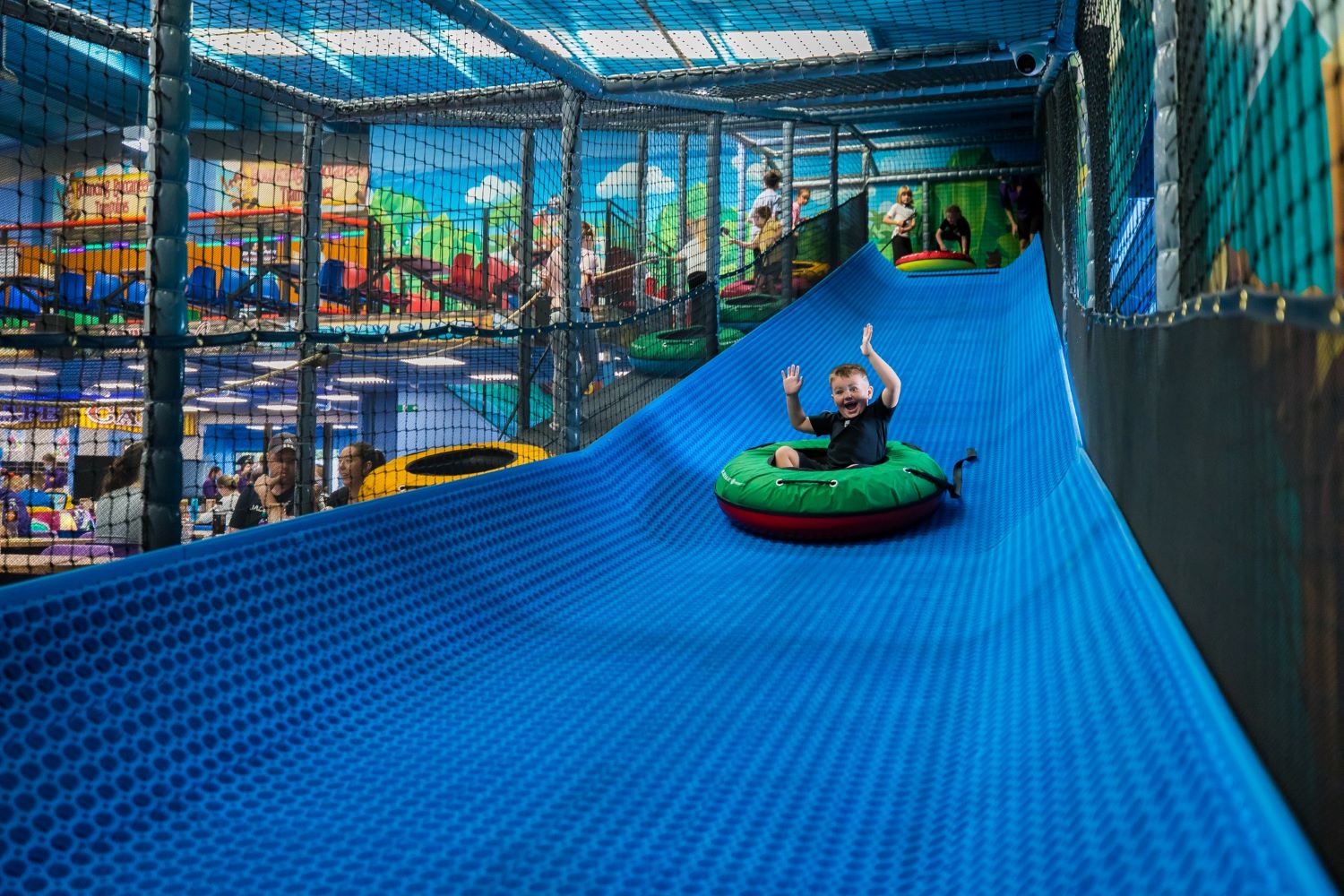 child sliding in a rubber ring at Fun Shack Middlesbrough