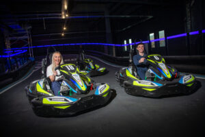 Two people on electric karts at Level X