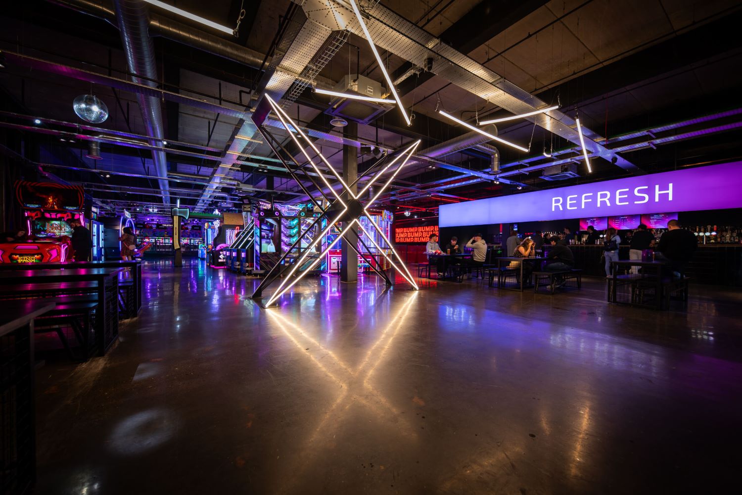Entrance to Level X with neon lights, arcade games and refresh bar