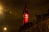 Middlesbrough town hall clock tower at night illuminated in red