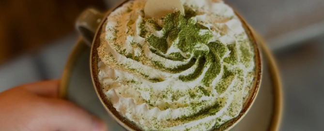 Coffee with whipped cream and pistachio dusting from Steam and Bean