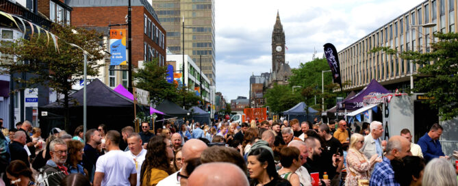 a crowded orange pip market with the middlesbrough clock tower in the background