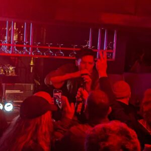 A singer performing to a crowd at Twisterella.