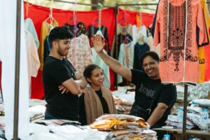 Three people at Middlesbrough Mela's market bazzar.