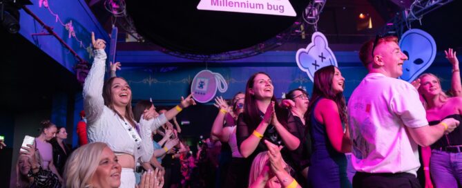A crowd of people smiling at a club.