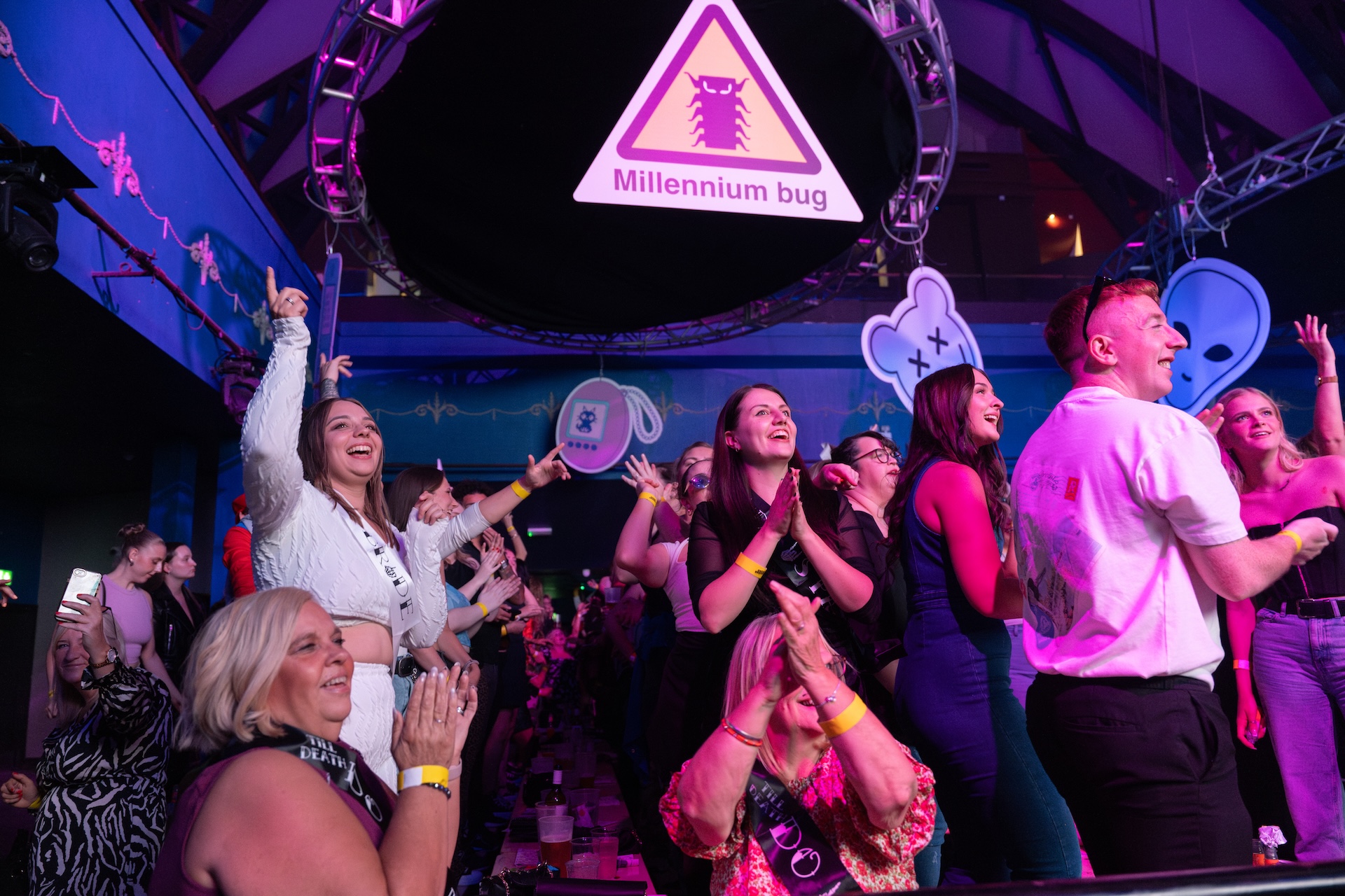 A crowd of people smiling at a club.