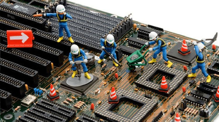 toy construction workers labouring on a motherboard