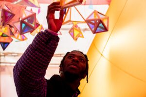 A person touching an exhibt at Happy Rooms