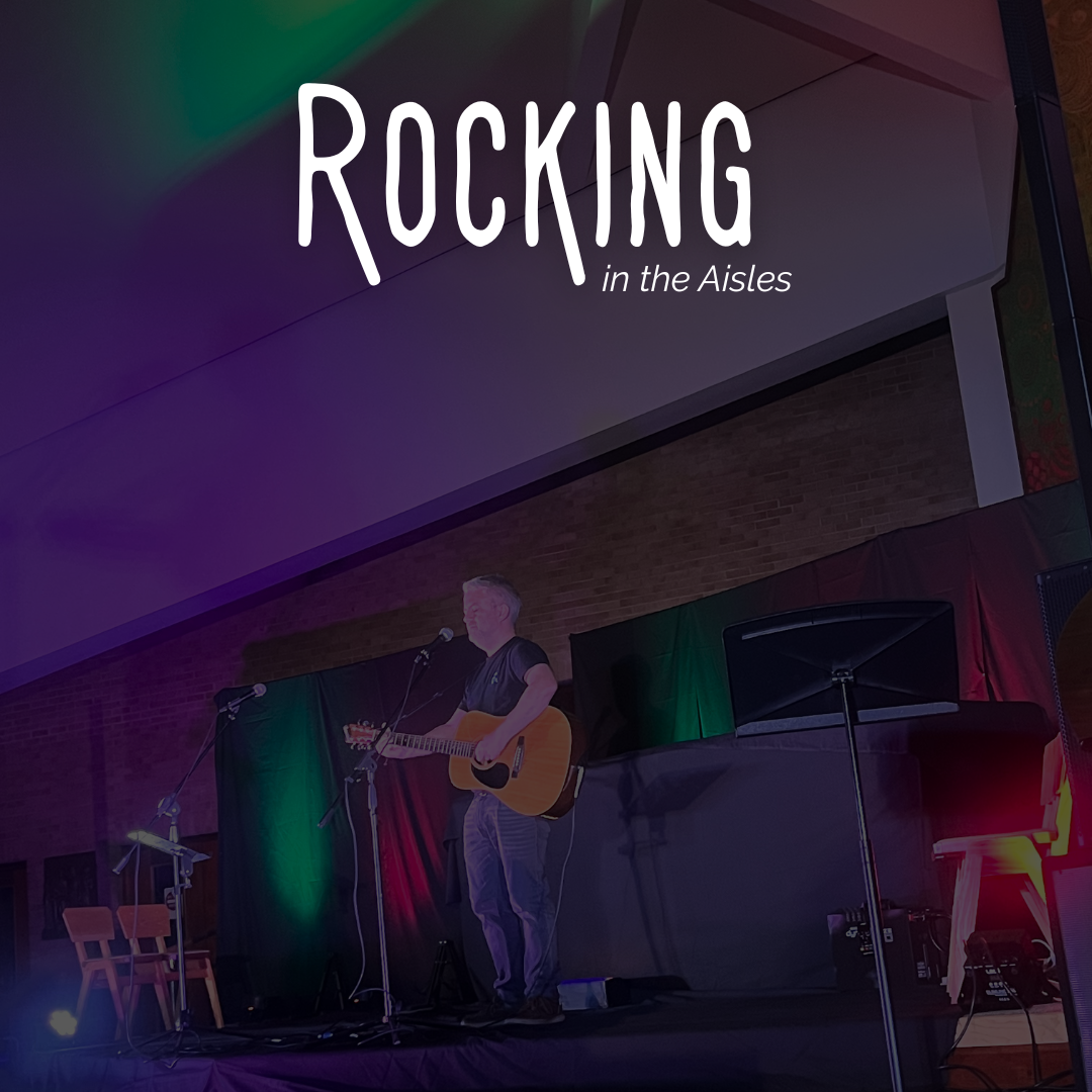A man playing acoustic guitar on stage with the words 'Rocking in the aisles' at the top.